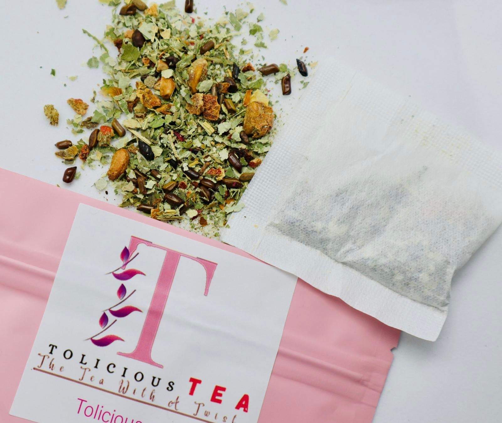 Tolicious wellness tea and detox gummies pack with loose herbal tea and a filled tea bag